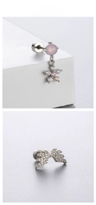 Detailed shot of silver heart and star earrings with pink zircon beads on display