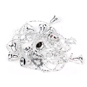 Silver beaded Christmas chain with bells and hollow tree ornaments on white background