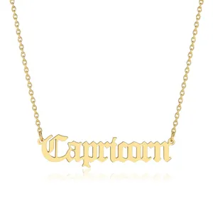 Detailed view of gold Capricorn pendant with gothic lettering on a stainless steel chain