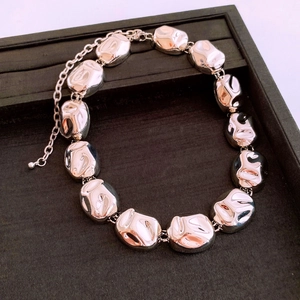 Detail of silver liquid lava link necklace with irregular oval shapes on black velvet tray