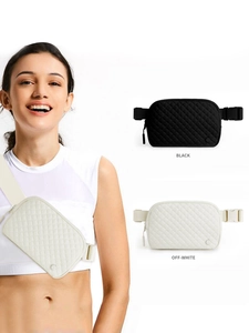 Detail view of quilted nylon belt bag in black and off-white colors on white background