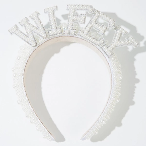 Close-up of white pearls bridal headband featuring WIFEY rhinestone lettering