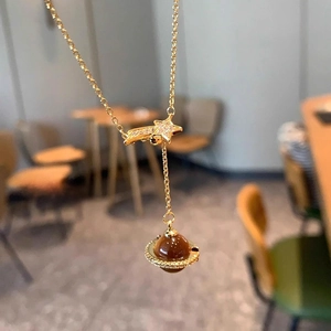 Starry sky necklace with star charm and tiger eye planet pendant in gold plating