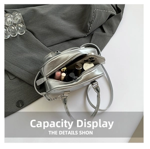 Internal view of a silver metallic bowling bag showing capacity for phone and cosmetics