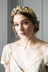 Detailed view of a golden laurel leaf bridal headband with intricate metallic texture