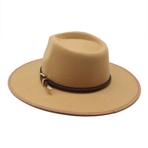 Close-up of camel wool fedora hat with braided brown band and gold metal buckle detail