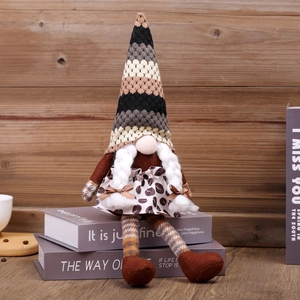 Gnome de Noël tricoté avec long chapeau et imprimé léopard sur des livres en bois