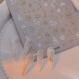 Golden Christmas nail stickers featuring reindeer and tree patterns with 3D embossed texture
