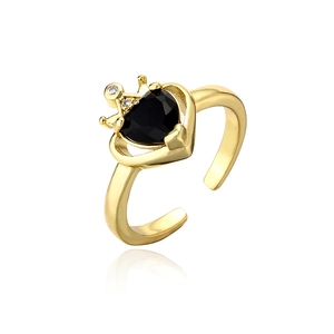 Macro detail of crown heart ring with black stone and adjustable gold plated band