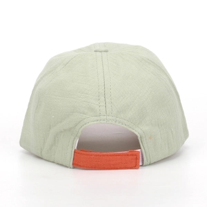 Detail view of children's baseball cap back with orange adjustable strap and green fabric