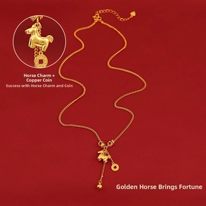 Macro shot of gold pony pendant with ancient coin charm on minimalist link chain