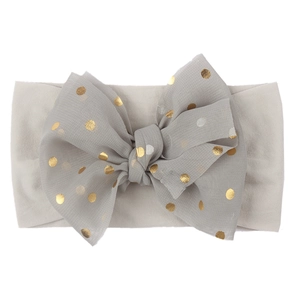 Gray soft nylon baby headband with a large chiffon gold polka dot bow accessory