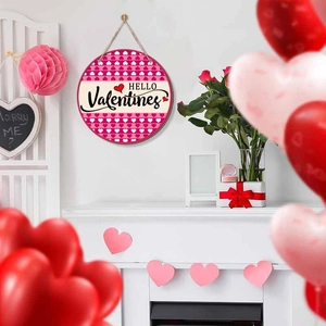 Pink heart Valentines wooden sign with Hello Valentines text in cozy home setting