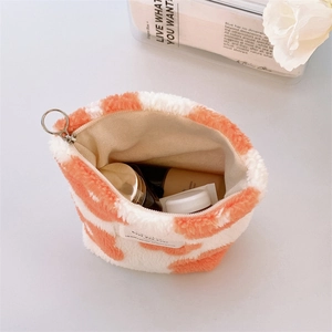 Orange and white plush makeup bag with cow pattern and metal zipper closure