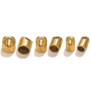 Macro view of six gold cylindrical stainless steel cord ends for DIY jewelry making
