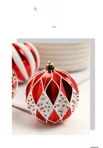 Gros plan d'une boule de Noël rouge avec texture losange blanc et attache dorée de luxe