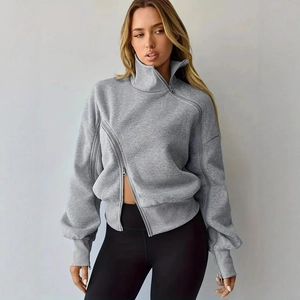 Detail of grey sweatshirt showing unique asymmetrical slant zipper and high collar design