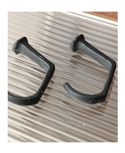 Macro shot showing the rugged texture and cast iron finish of retro nail-style hooks