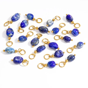 Detailed view of natural blue stone pendants with gold-plated metal loops for DIY jewelry