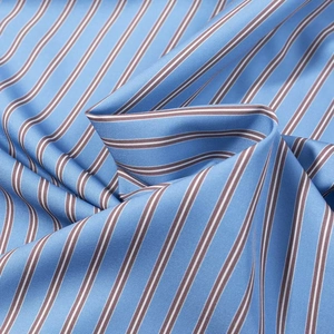 Close-up of blue and white striped cotton fabric with fine diagonal twill texture