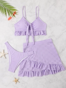 Detailed flat lay of lavender purple crochet bikini set with matching beach skirt