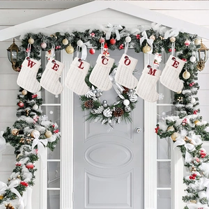Detailed knit Christmas stockings with red embroidered WELCOME letters and Santa hats