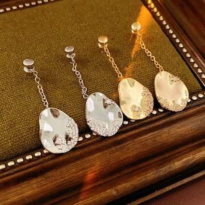 Détail de boucles d'oreilles martelées plaquées or 18k avec cristaux brillants