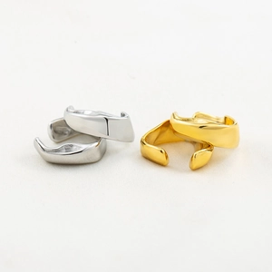 Irregular wavy gold and silver metal ear cuffs with a minimalist geometric design