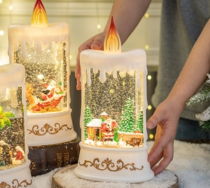Detailed view of Santa Claus water candle light with glitter snow and golden relief base