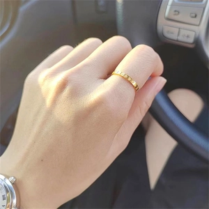 Minimalist 2mm gold plated stainless steel ring with engraved heart pattern on finger