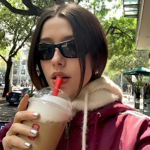 Y2K Cyberpunk sporty sunglasses with black frames worn with a red streetwear hoodie