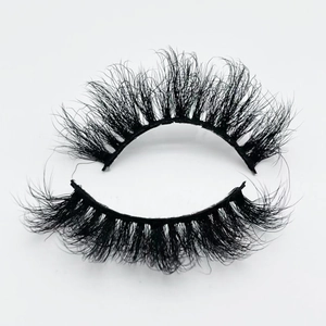 Close-up of 20mm thick curly faux mink eyelashes showing texture on white background