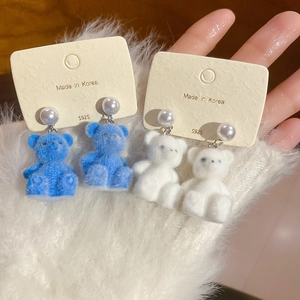 Detail of S925 silver needle earrings with flocked teddy bears and white pearls