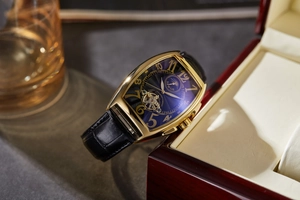 Detailed macro shot of a gold tonneau automatic mechanical watch with skeleton dial