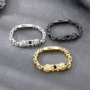 Detail of wolf head Byzantine chain bracelets in gold, silver and black steel finish