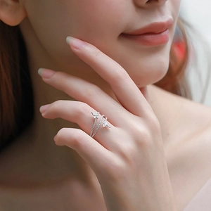 Detailed view of silver double-layered butterfly ring with sparkling zircon stones on finger