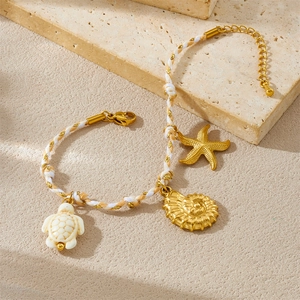 Braided ocean-themed bracelet with gold conch, starfish and white turtle pendants