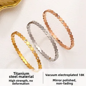 Detail of three honeycomb bracelets in gold, silver and rose gold with zircon inlay