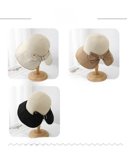 Cappelli di paglia da donna in beige, kaki e nero con fiocchi decorativi in tessuto