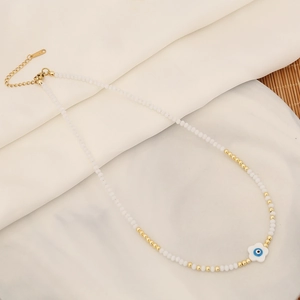 Detail of beaded necklace showing the S925 sterling silver stamp and evil eye heart pendant