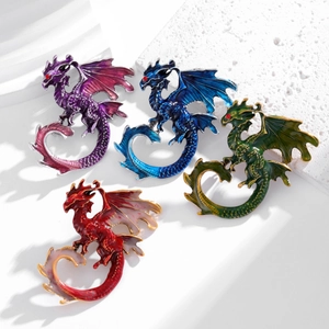 Exaggerated pterosaur brooches in purple, blue, green, and red enamel with red crystal eyes