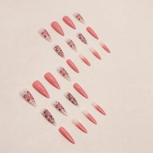 Long almond press-on nails with sunset yellow gradients and five-petal flower art