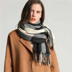 Classic black and white checkered faux cashmere scarf with fringe tassels on a model