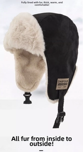 Detail view of black winter trapper hat with thick beige faux fur and buckle strap
