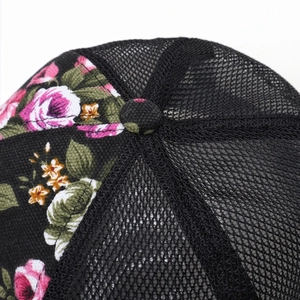 Close-up of baseball cap crown with floral pattern fabric and breathable black mesh