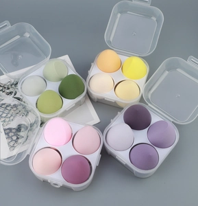 Detailed set of four multi-colored makeup sponges in transparent dustproof storage boxes