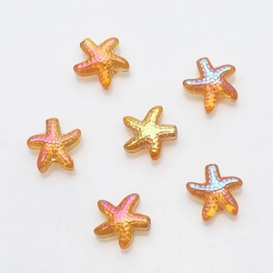 Macro detail of six orange-gold starfish glass crystal pendants for DIY jewelry making