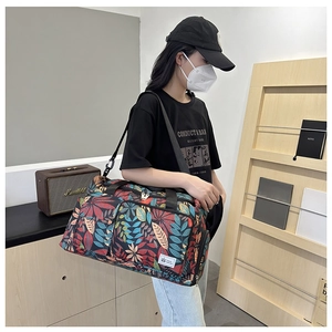 Travel tote bag featuring colorful leaf prints and adjustable shoulder strap for gym