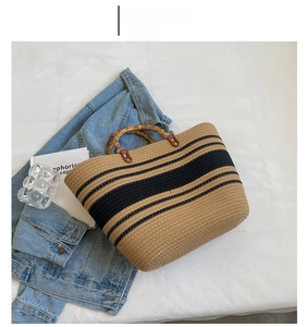 Detailed close-up of stripe straw tote bag with bamboo handles and chic woven texture