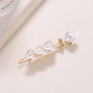 Elegant gold flower hair clip with white shell petals and sparkling rhinestones